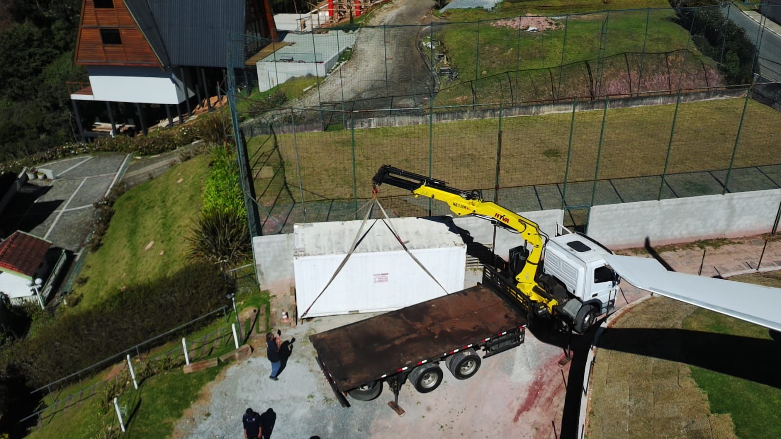 Vista aérea do posicionamento de container refrigerado com munck